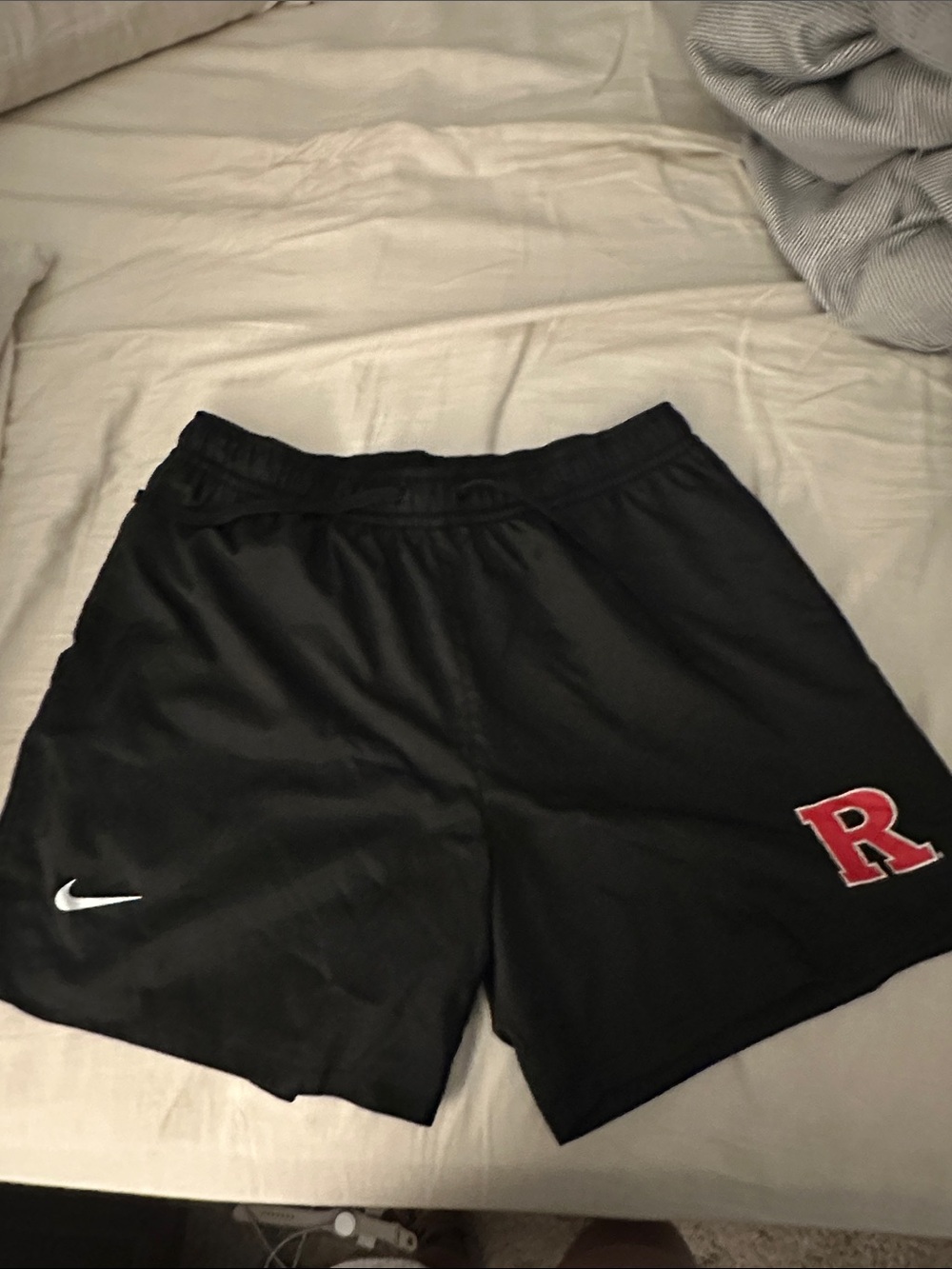 Nike Black Athletic Shorts with Red 'R' Patch and White Swoosh